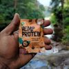 Hemp Protein Bites Coco flavor and a scenic water flowing background