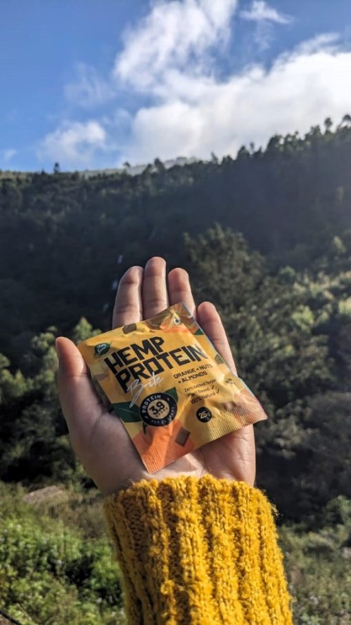 Holding Hemp Protein Bites Orange in hand